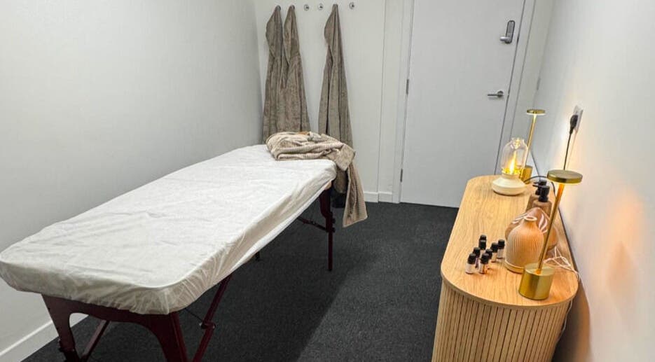 Calm treatment room at Clear Canvas Tattoo Removal, Peterhead, Scotland, GB, with massage table and ambient lighting.