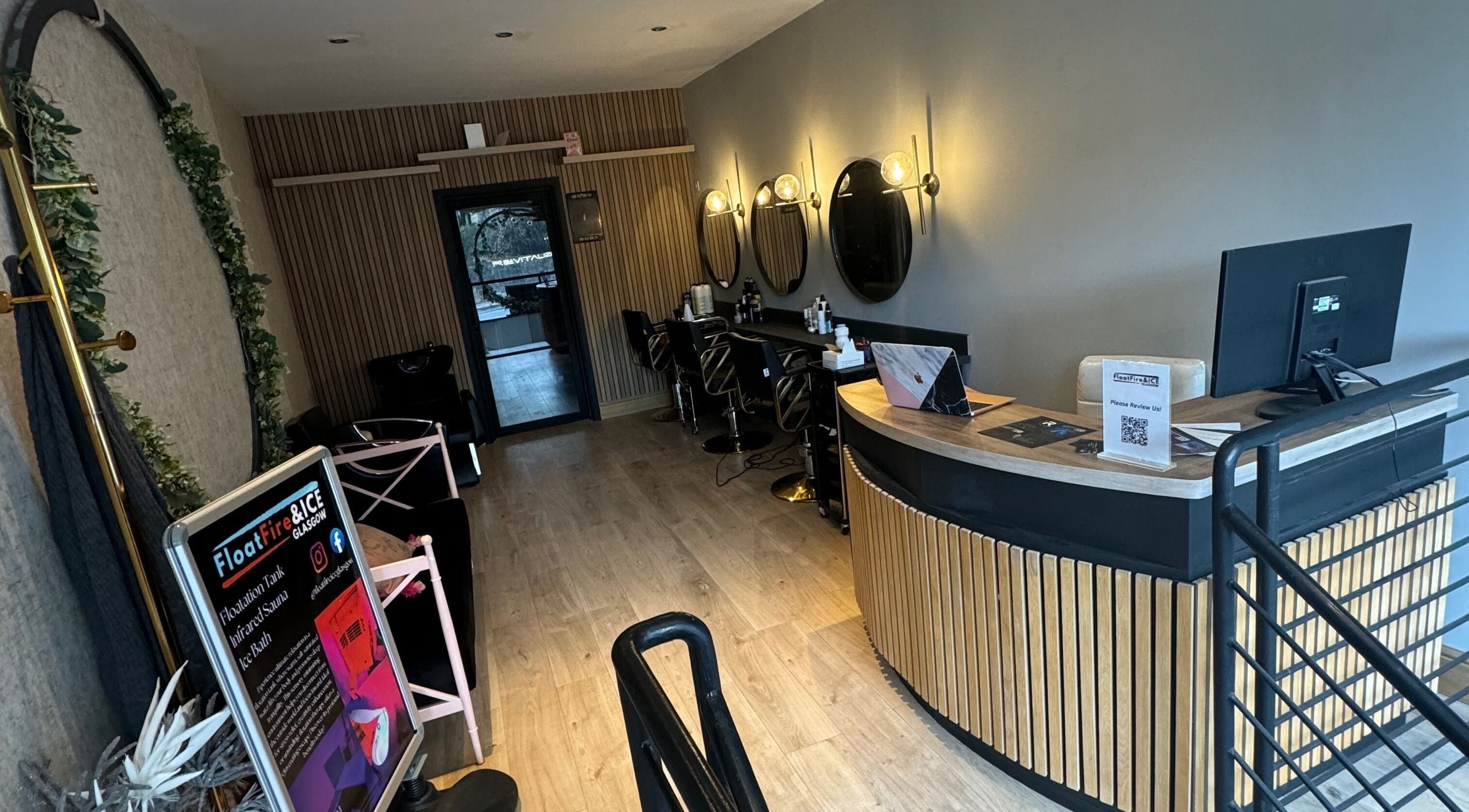 Sophisticated salon interior at WouldBWellness, Lenzie, Scotland, GB, featuring elegant wooden decor and styling stations.