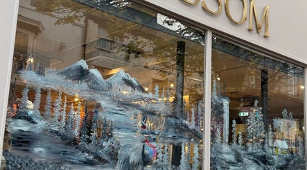 Stunning winter-themed mural on Amy Nicole storefront in Neath, Wales, GB, showcasing nature and wildlife.