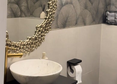 Luxurious bathroom at Amy Nicole, Neath, Wales, GB with ornate mirror and marble sink.