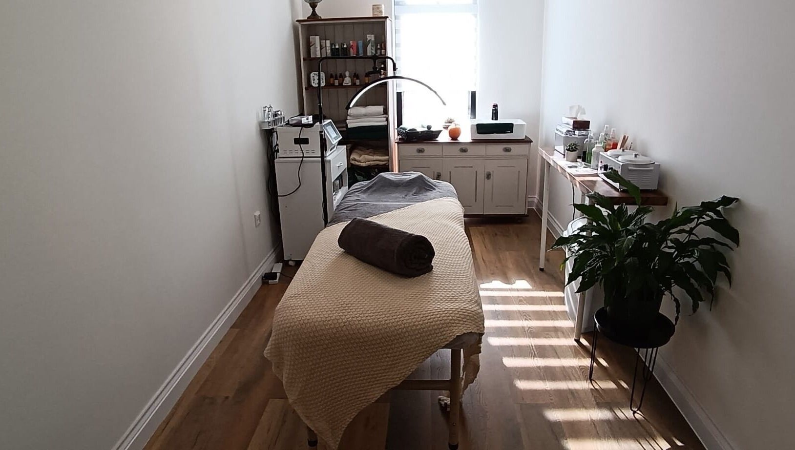 Massage room at NUDE, London, England, GB, featuring a cozy bed, modern decor, and tranquil ambiance.