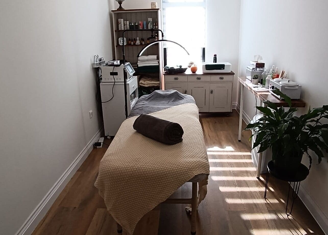 Massage room at NUDE, London, England, GB, featuring a cozy bed, modern decor, and tranquil ambiance.