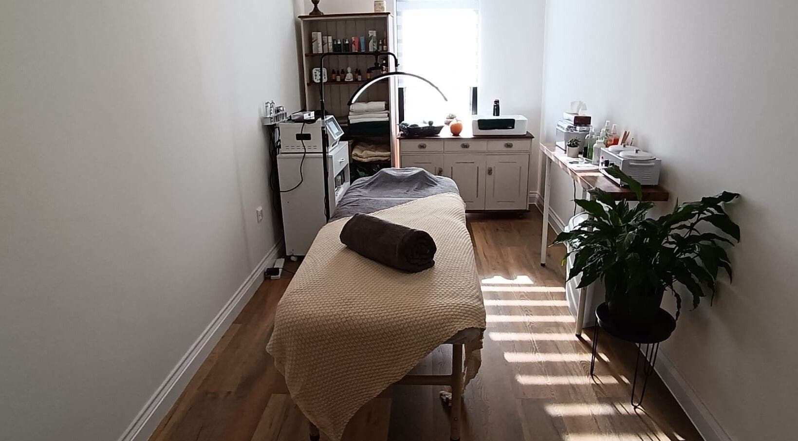 Massage room at NUDE, London, England, GB, featuring a cozy bed, modern decor, and tranquil ambiance.