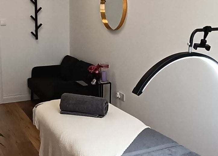 Cozy treatment room at NUDE in London, England, GB with massage table and calming decor.