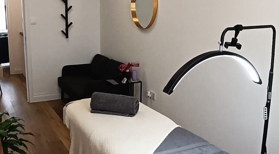 Cozy treatment room at NUDE in London, England, GB with massage table and calming decor.