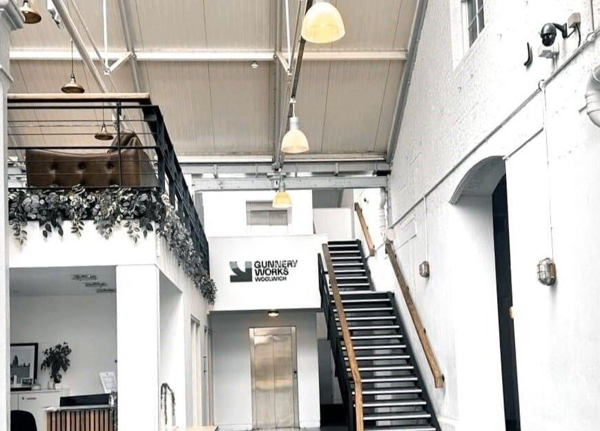 Spacious interior of NUDE, London, England, GB, featuring modern design elements and a stylish staircase.