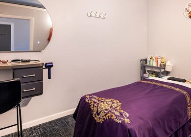 Relaxing spa room at Shangrila Head Spa, Yorktown Heights, NY, US, with a purple massage table and serene decor.