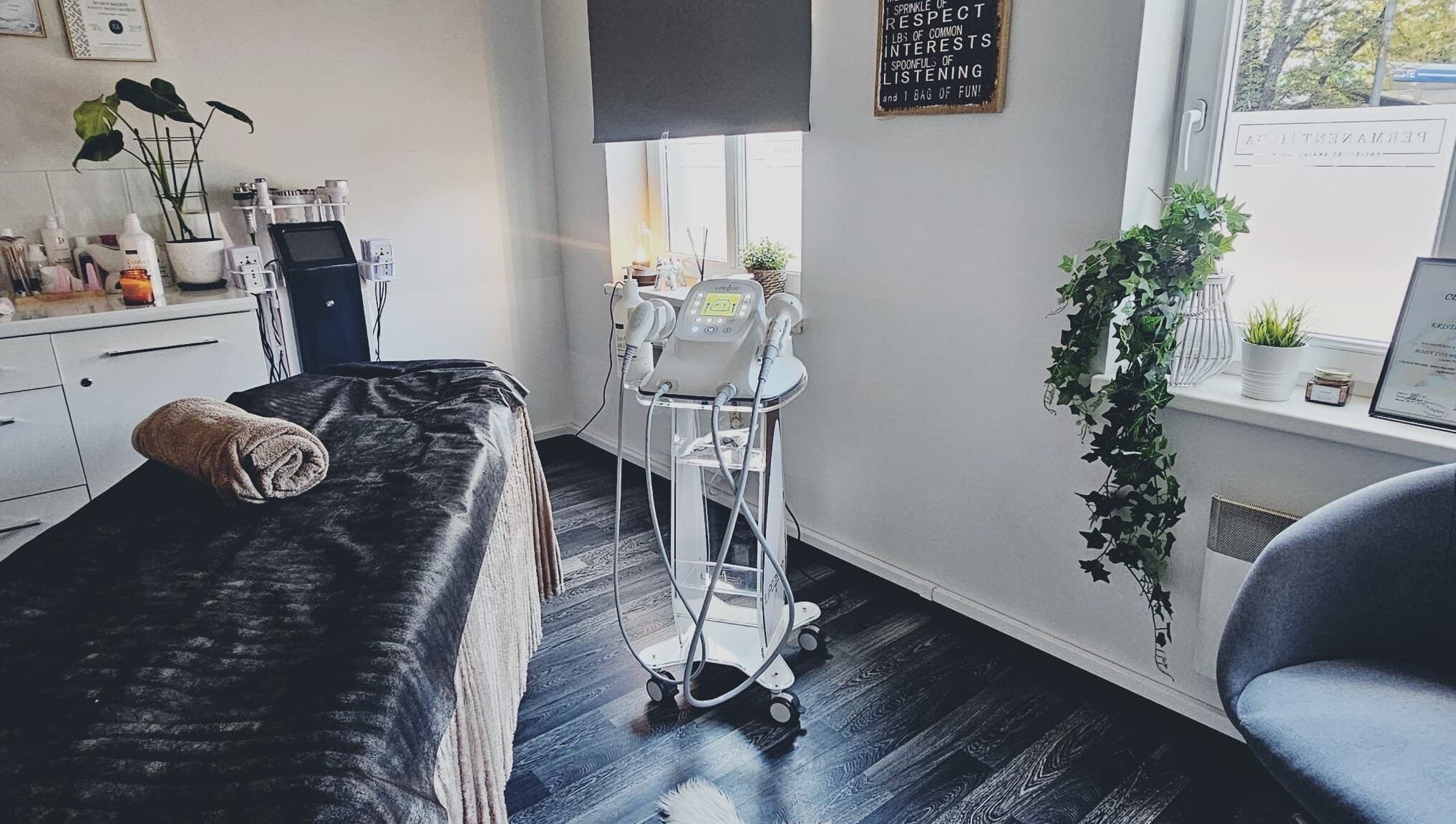 Cozy treatment room at TheLittleBirdSPA in Rīga, LV, featuring a massage table and modern beauty equipment.