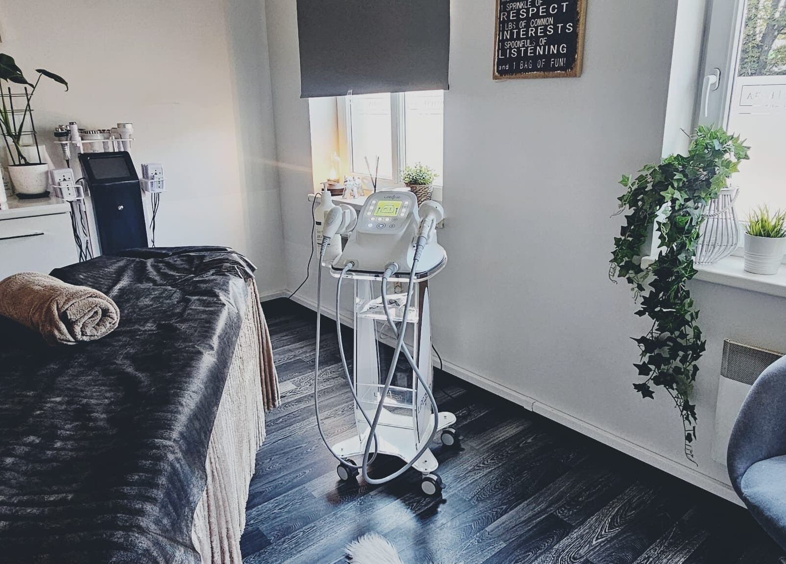 Cozy treatment room at TheLittleBirdSPA in Rīga, LV, featuring a massage table and modern beauty equipment.