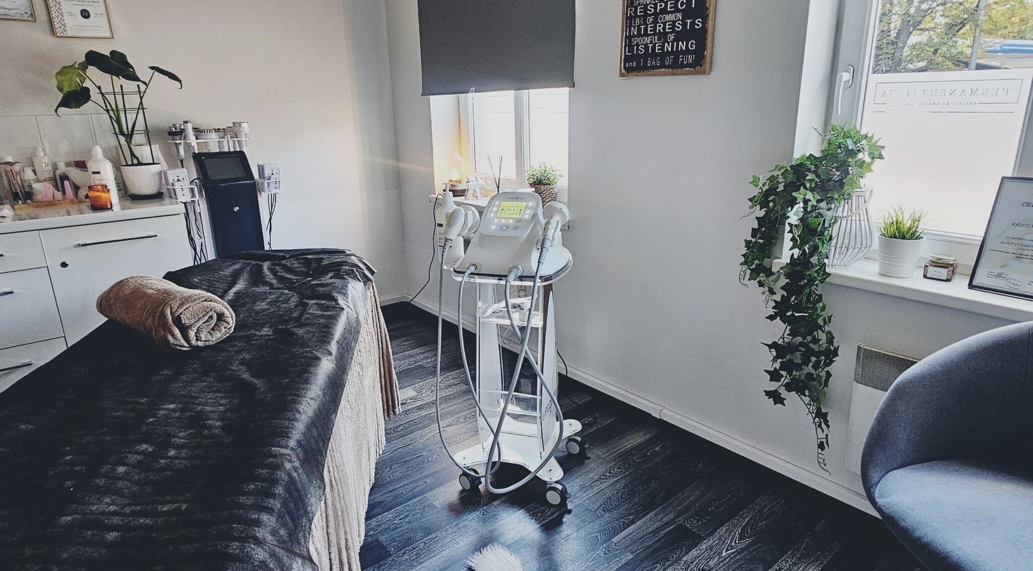 Cozy treatment room at TheLittleBirdSPA in Rīga, LV, featuring a massage table and modern beauty equipment.