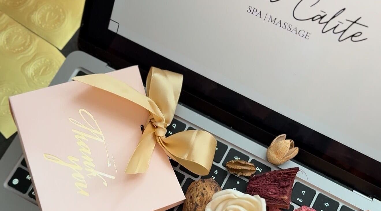 Laptop with a golden gift box and dried flowers at TheLittleBirdSPA, Rīga, LV.