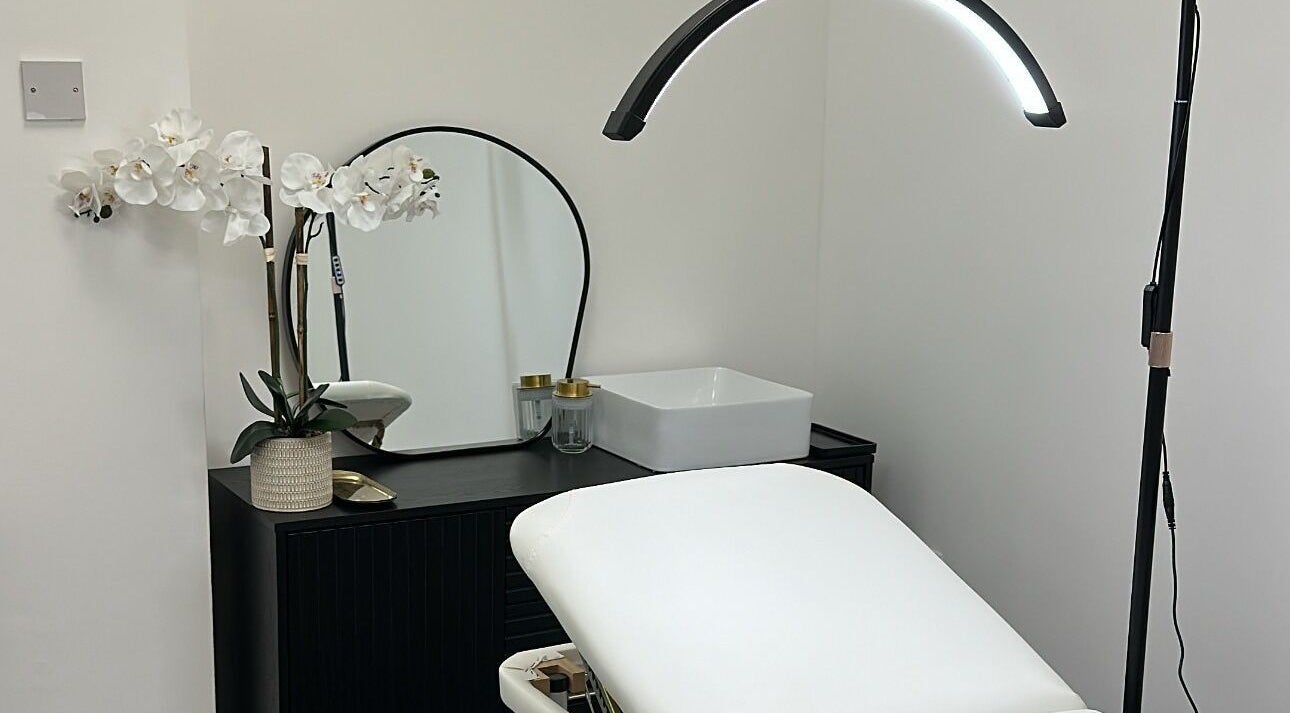 Modern treatment room at PM Aesthetics, Cardiff, Wales, GB, featuring elegant decor and comfortable seating.