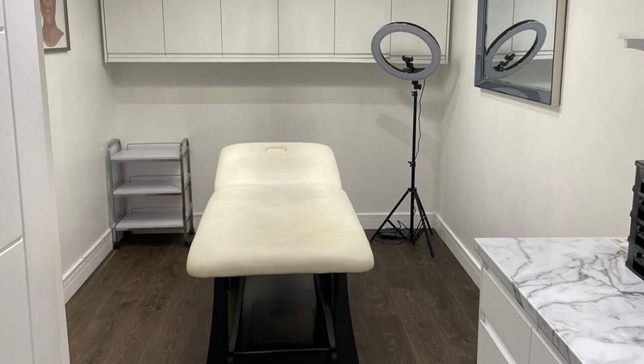 Luxurious treatment room at Evie’s luxe ink, Swindon, England, GB with a plush, inviting massage table.