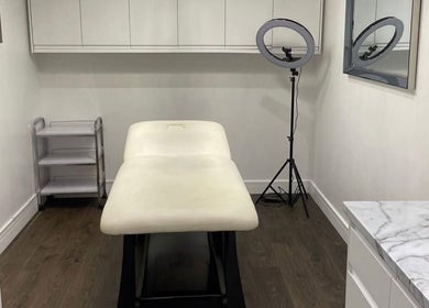 Luxurious treatment room at Evie’s luxe ink, Swindon, England, GB with a plush, inviting massage table.