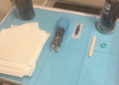 Tattoo tools at Evie’s Luxe Ink in Swindon, England, GB, arranged neatly on a blue mat.