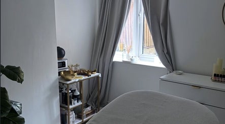 Peaceful interior of Hana’s Brow Bar, London, England, GB with cozy treatment table and natural light.