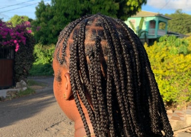 Intricate braids at Destiny’s Designs, Grande-Riviere, Gros Islet, LC, showcasing expert styling in a serene setting.
