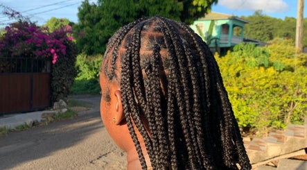 Intricate braids at Destiny’s Designs, Grande-Riviere, Gros Islet, LC, showcasing expert styling in a serene setting.