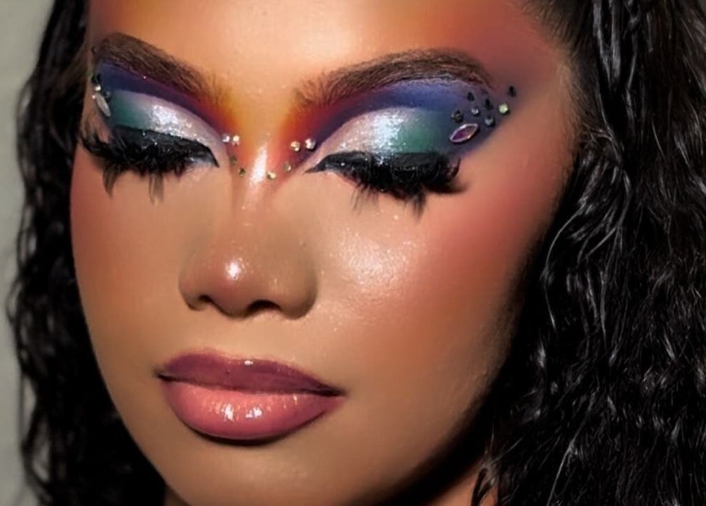 Vibrant, artistic eye makeup showcased at Emerald Empire, Willemstad, Curaçao, CW. Features bold colors and jewels.