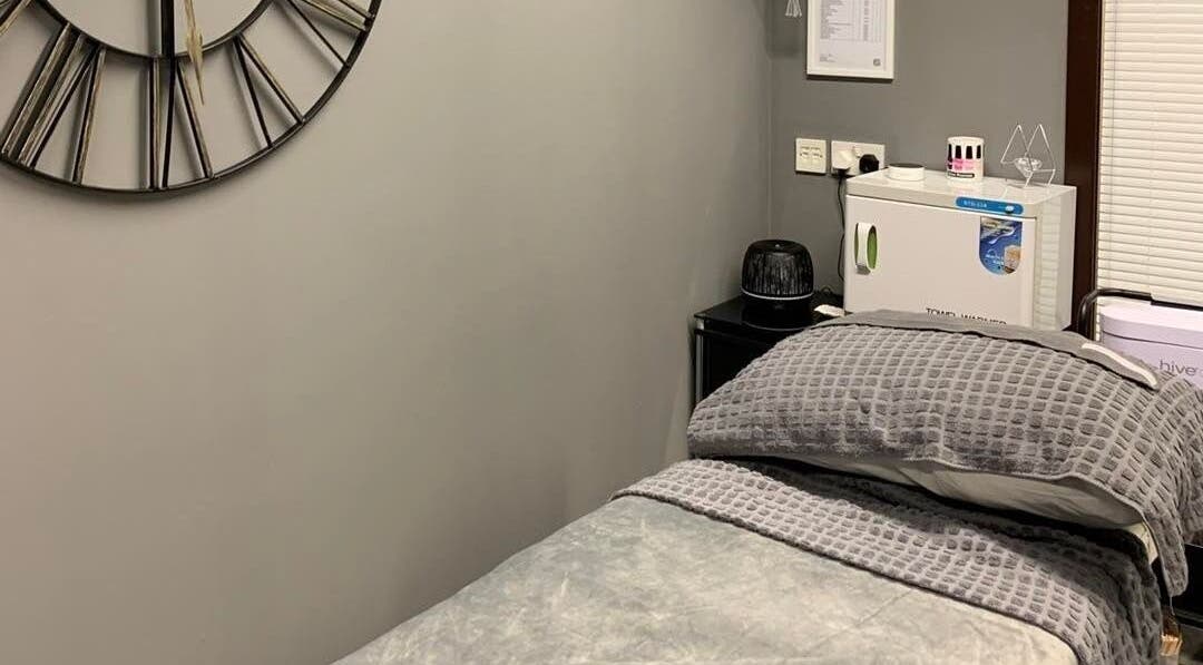 Relaxing treatment room at Chloe Pearson Beauty, Castle Avenue Industrial Estate, Scotland, GB, with a plush bed.