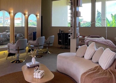 Elegant interior of Sara Anna Spa in Bali, Bali, ID, featuring cozy seating and chic styling stations.