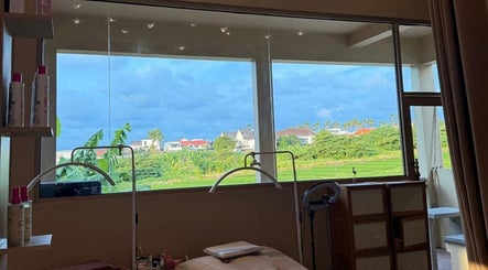 Relaxing spa room at Sara Anna Spa, Bali, Bali, ID with scenic green field view through large windows.