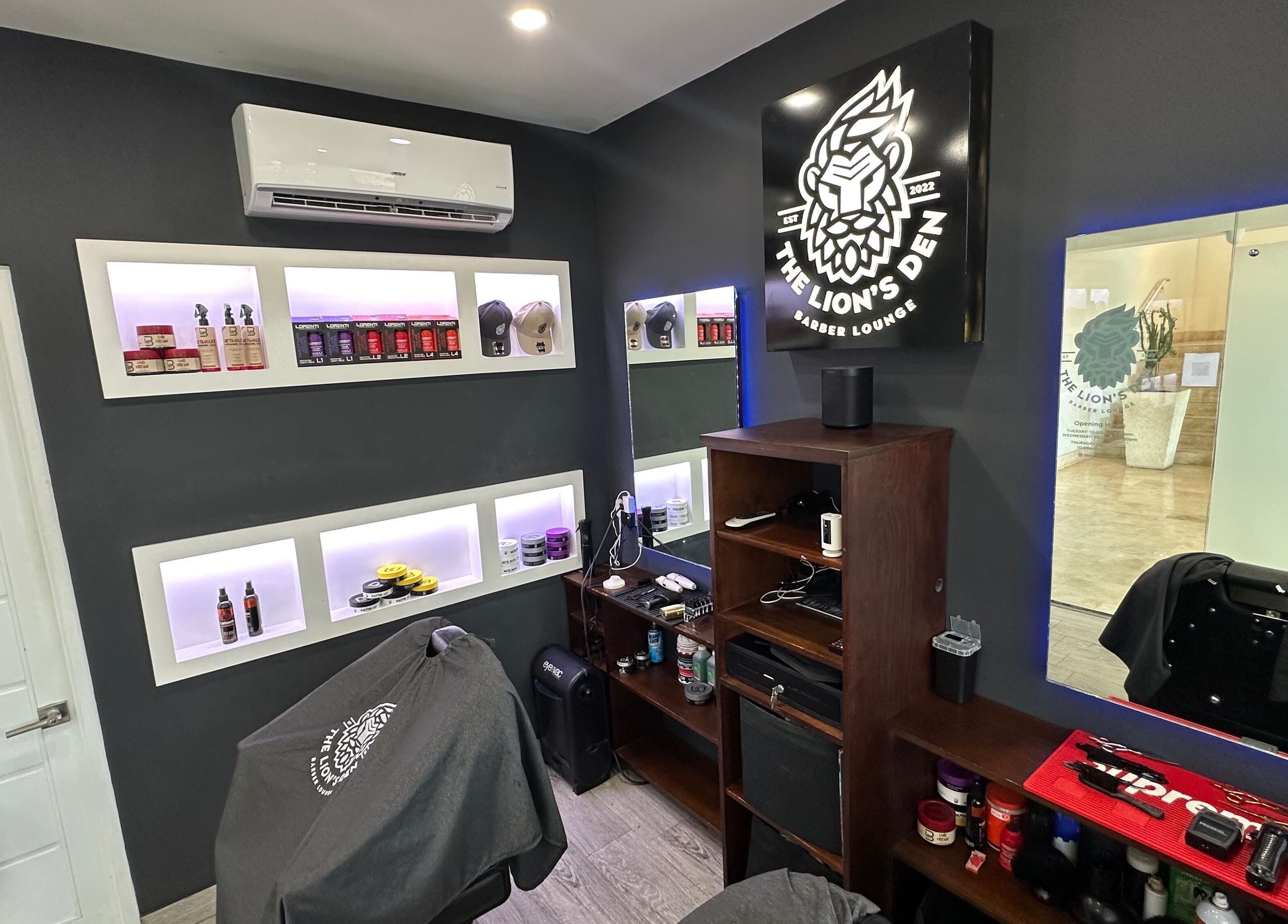 Interior of The Lion's Den Barber Lounge in Holetown, Saint James, featuring modern decor and grooming products.