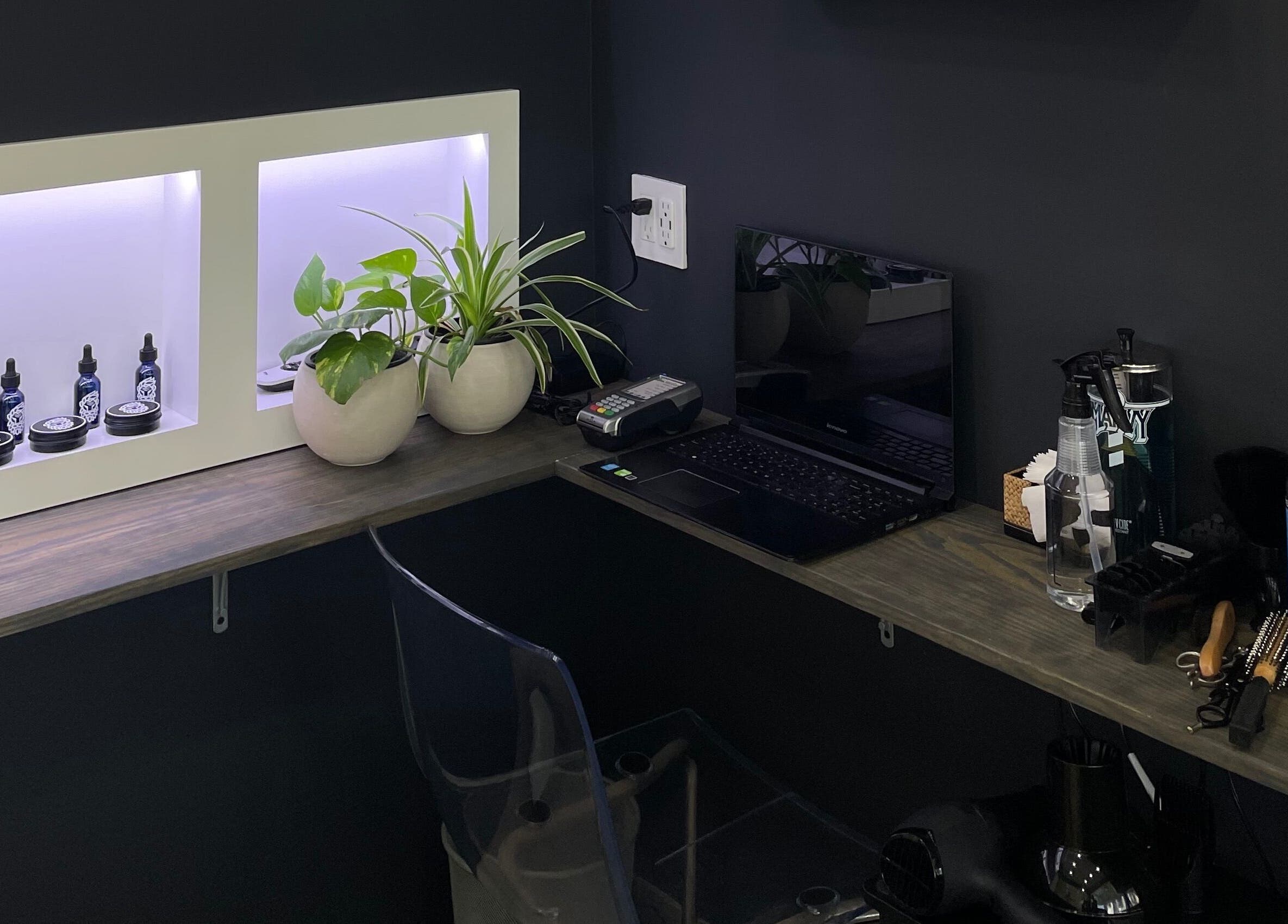 Stylish barber workspace at The Lion's Den Barber Lounge, Holetown, Saint James, BB with plants and products.