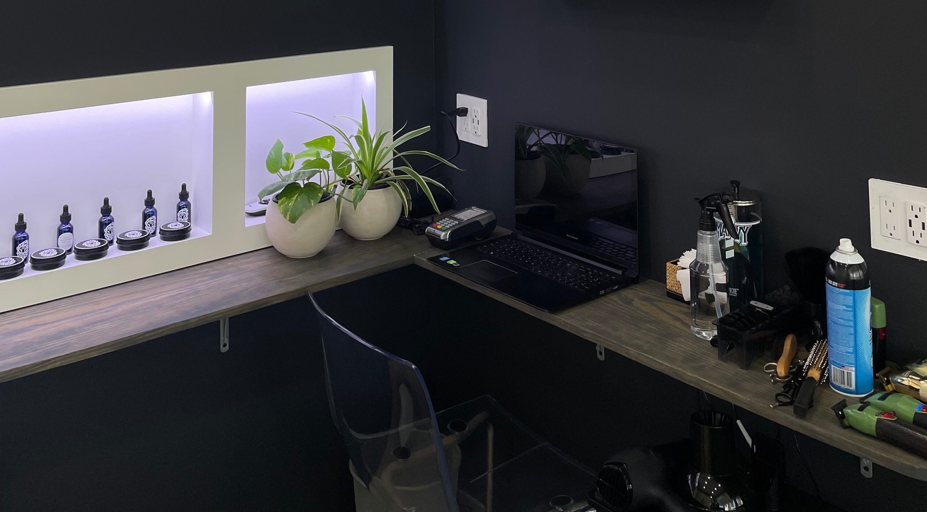 Stylish barber workspace at The Lion's Den Barber Lounge, Holetown, Saint James, BB with plants and products.