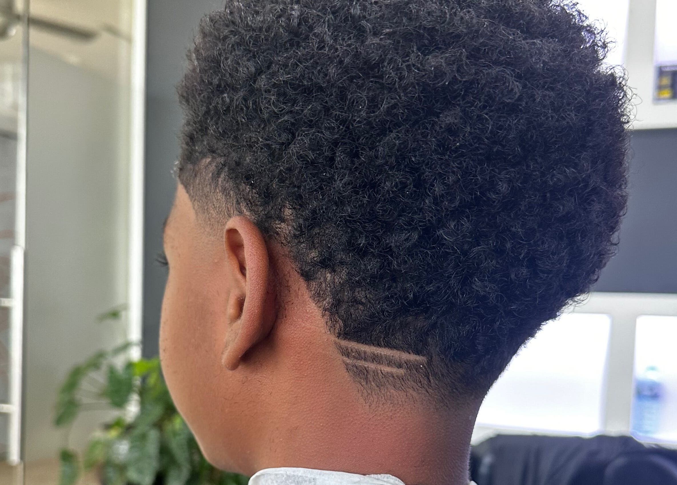 Close-up of a stylish fade haircut at The Lion's Den Barber Lounge, Holetown, Saint James, BB.