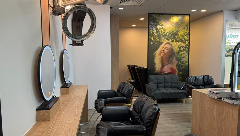 Chic interior of Focus Hairdressing in Singapore, Singapore, SG featuring stylish seating and mirrors.