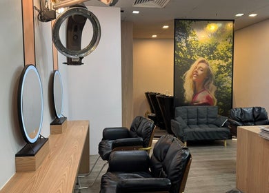 Chic interior of Focus Hairdressing in Singapore, Singapore, SG featuring stylish seating and mirrors.