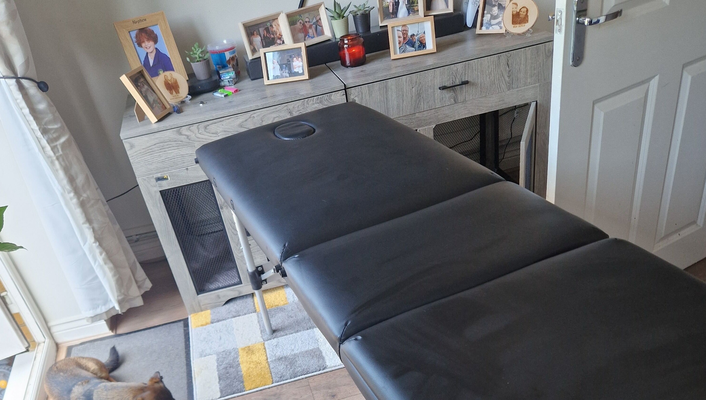 Massage table at CJB Beauty & Aesthetics, Ashford, England, GB, with decor and cozy ambiance.