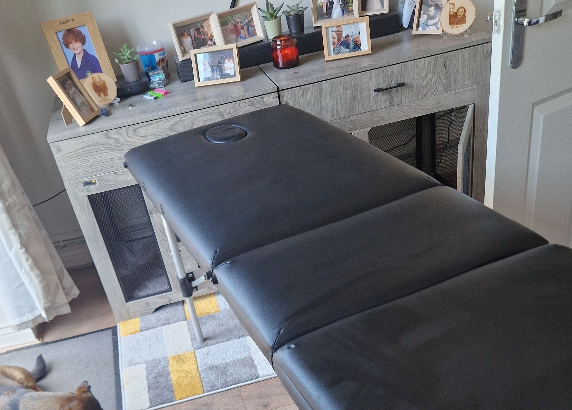 Massage table at CJB Beauty & Aesthetics, Ashford, England, GB, with decor and cozy ambiance.