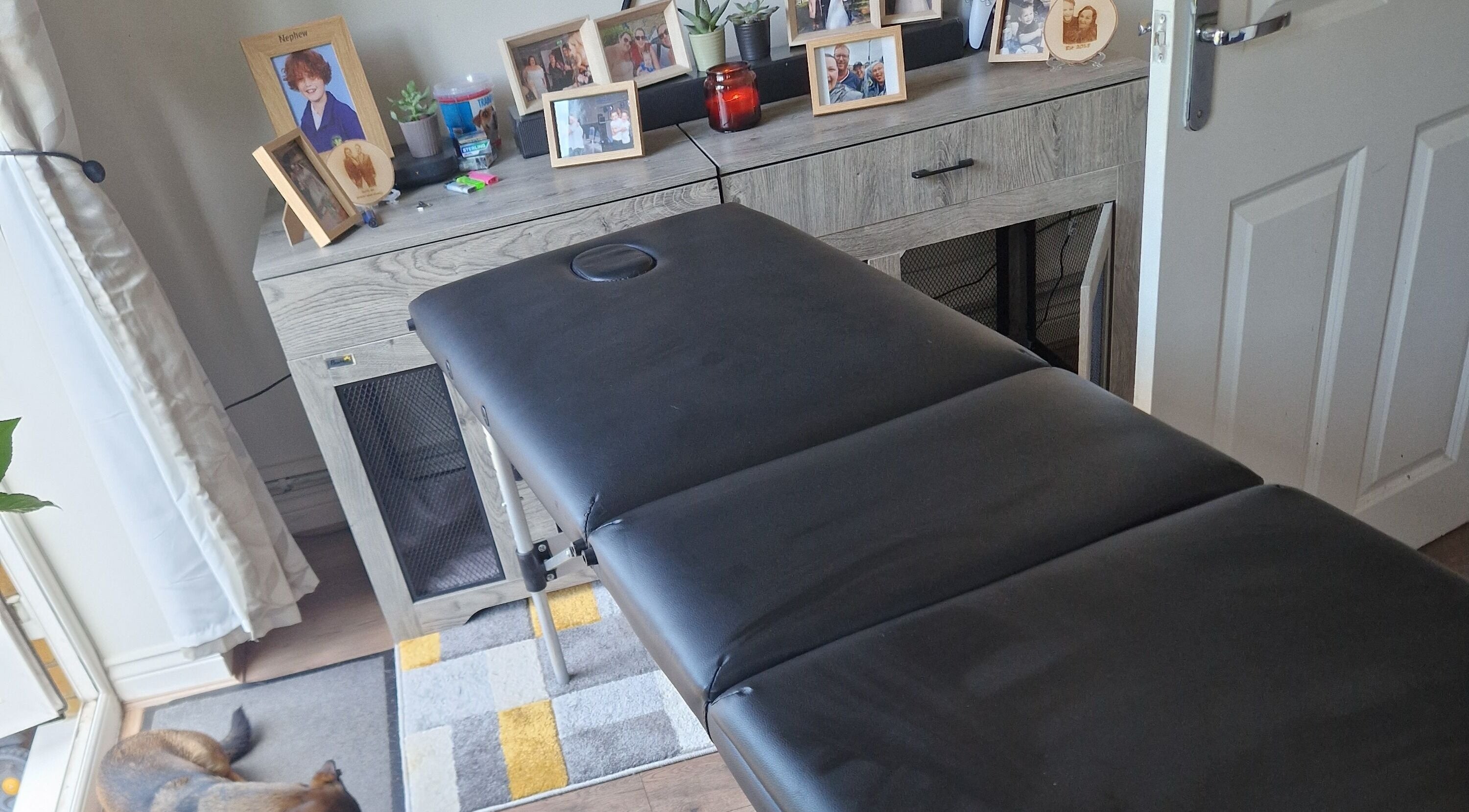 Massage table at CJB Beauty & Aesthetics, Ashford, England, GB, with decor and cozy ambiance.