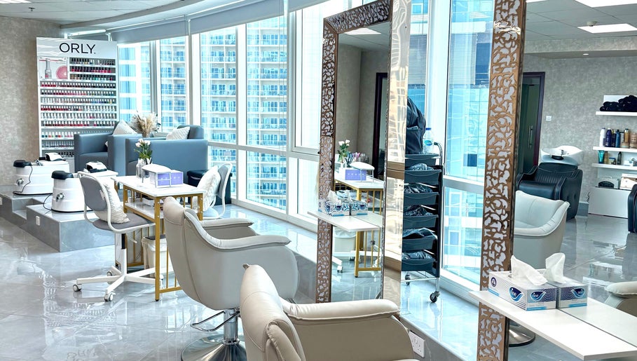 Elegant interior of Rosemarie Beauty Centre in Dubai, AE, showcasing modern chairs and nail polish display.