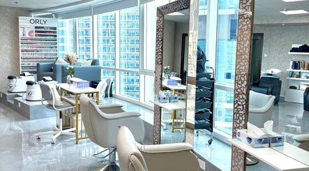 Elegant interior of Rosemarie Beauty Centre in Dubai, AE, showcasing modern chairs and nail polish display.