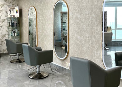 Modern salon interior with chic chairs and mirrors at Rosemarie Beauty Centre, Dubai, AE.