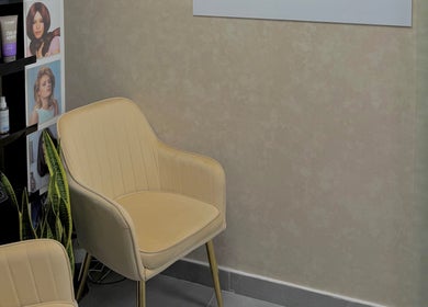 Elegant waiting area at Rosemarie Beauty Centre, Dubai, AE with plush chairs and beauty displays.