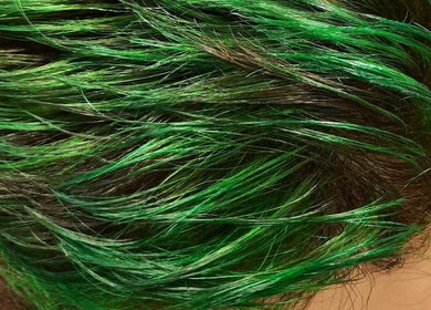 Vibrant green hair styled at R.M, London, England, GB, showcasing trendy hair color.