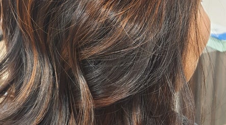 Close-up of highlighted hair at R.M, London, England, GB showcasing vibrant brown tones.