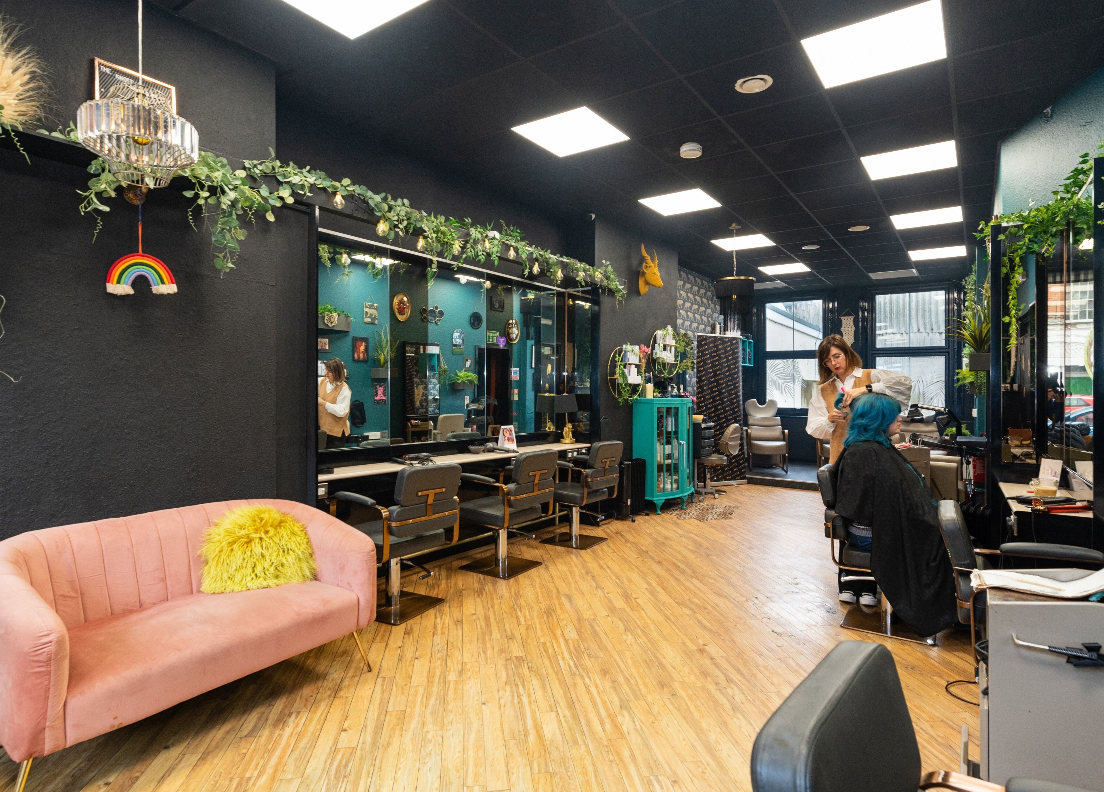 Chic interior of The Knott salon in Folkestone, England, GB, featuring vintage decor and modern styling stations.