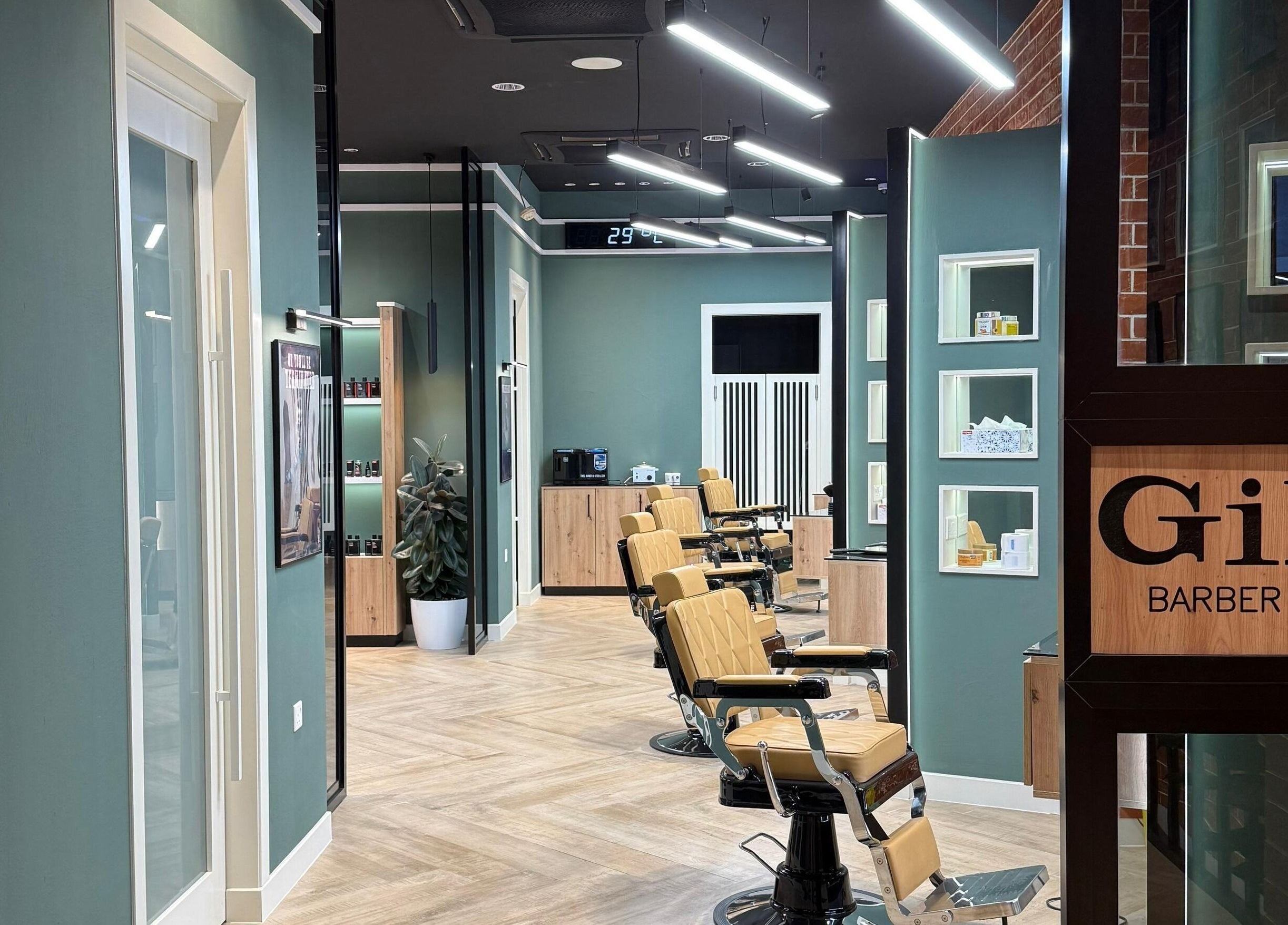 Interior of Gil’s Barbershop in Al Khobar, Eastern Province, SA, showcasing modern barber chairs and sleek decor.