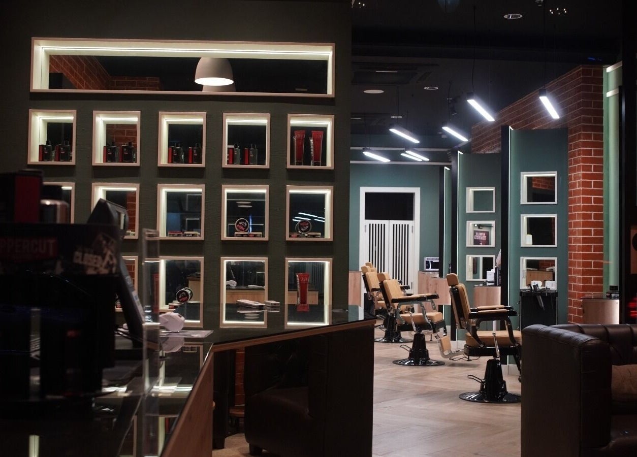 Interior of Gil’s Barbershop in Al Khobar, Eastern Province, SA, showcasing modern design and barber chairs.