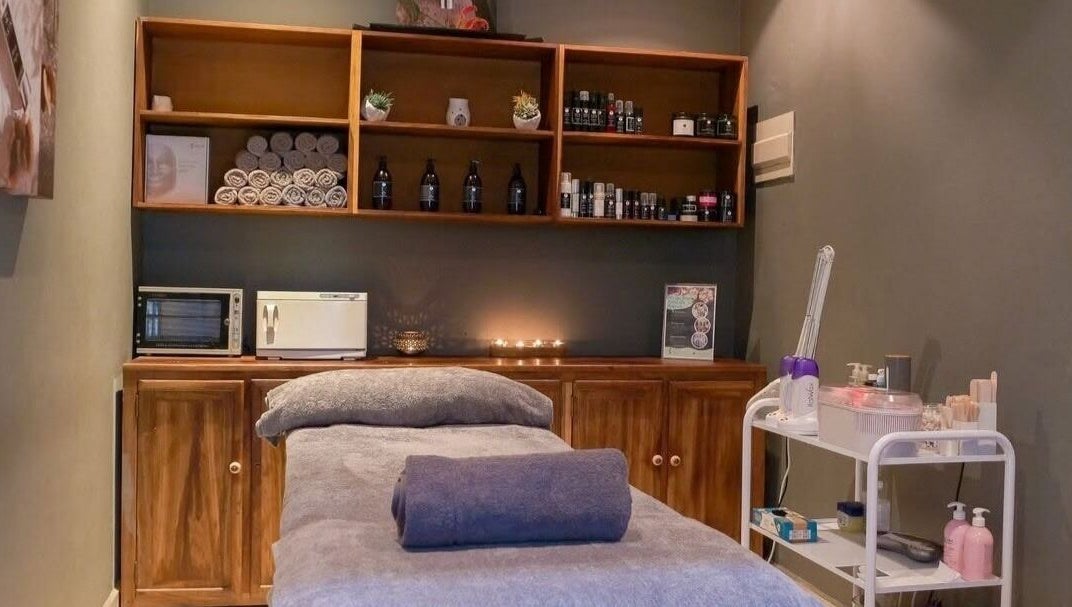Relaxing treatment room at Skin Spa-Sandys, Lusaka, Lusaka Province, ZM, showcasing a massage table and soothing ambiance.