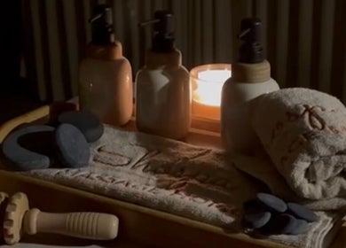 Relaxing spa setup at Shospa Home Service in Riyadh, Riyadh Province, SA, showcasing candles and massage tools.