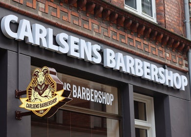 Carlsens Barbershop facade sign in Svendborg, DK. Classic barber styling on Kattesundet street.