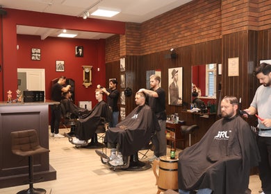 Inside Carlsens Barbershop, Svendborg • Kattesundet, showcasing skilled barbers at work. Svendborg, DK.