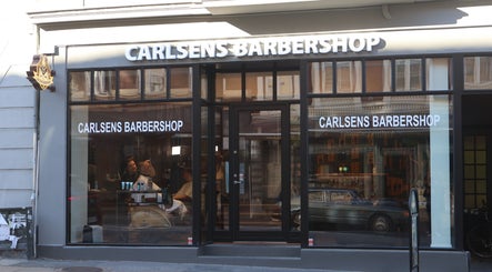 Facade af Carlsens Barbershop på M.P. Bruuns Gade, Aarhus, DK med reflekterende vinduer.