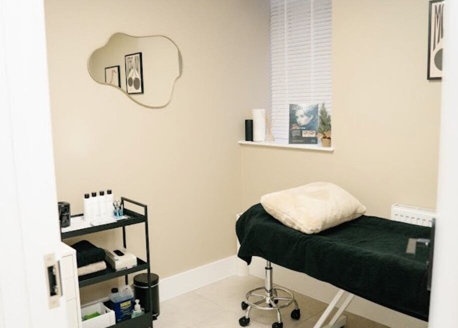 Calm treatment room at PureSkin Studio, Maidstone, England, GB. Features a cozy bed and beauty essentials.